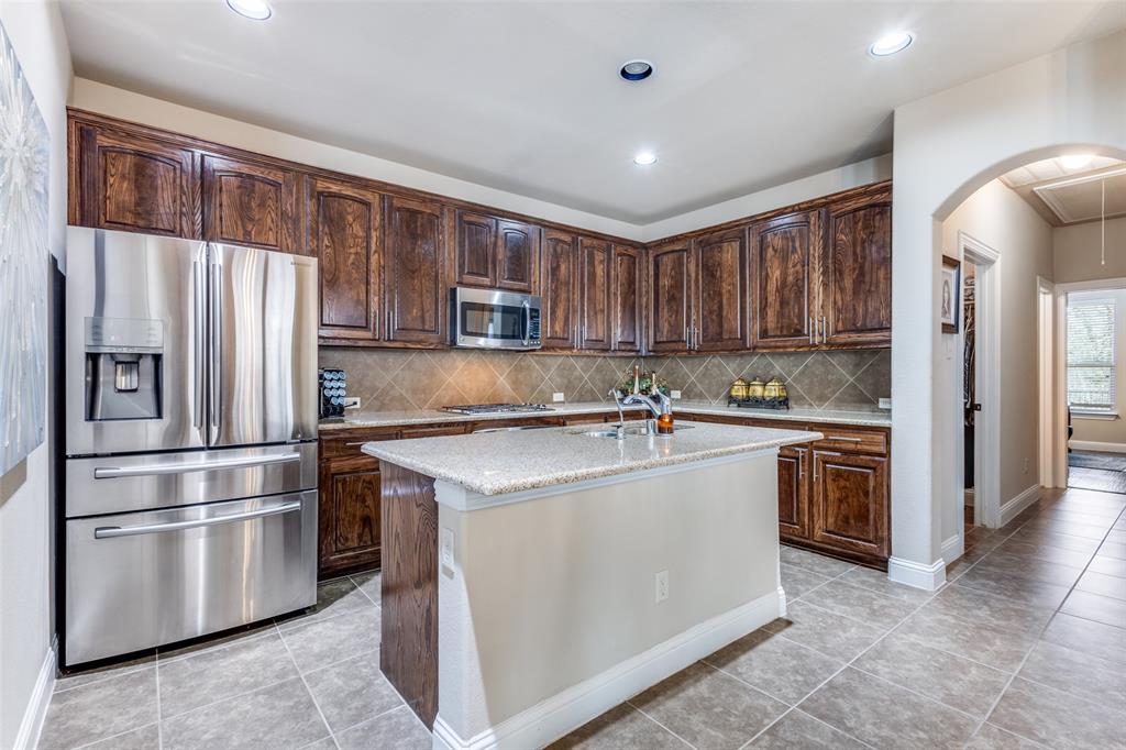 817 Deer Ridge Trail McKinney, TX 75072 - Photo 10 of 35 Kitchen with granite counters, island, SS appliances - Refrig stays - TONS of cabinets