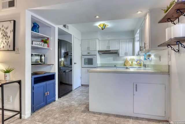 a kitchen with stainless steel appliances granite countertop a refrigerator and stove
