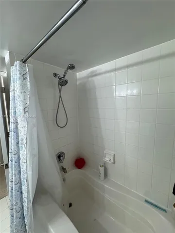 a bathroom with a bathtub and shower