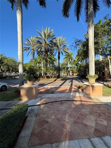 a view of swimming pool with palm trees