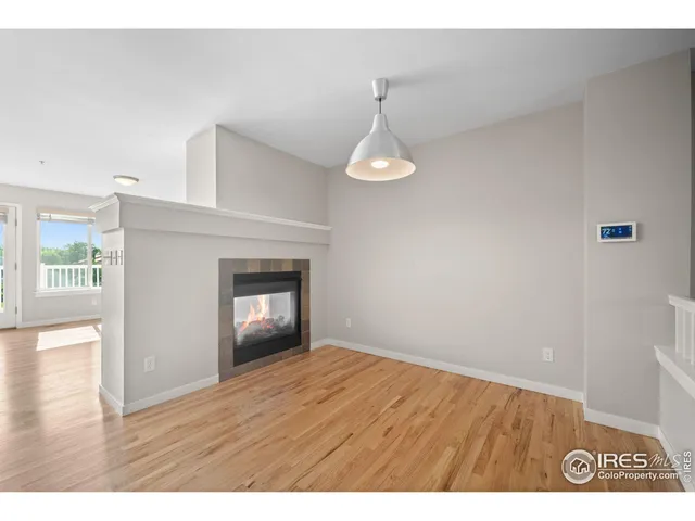 a view of an empty room and wooden floor
