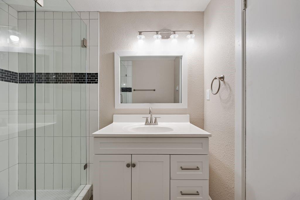 5706 Rocky Ridge Road Dallas, TX 75241 - Photo 14 of 31 a bathroom with a sink vanity and a mirror