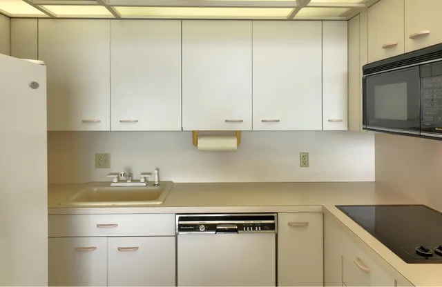 a kitchen with cabinets appliances and a sink