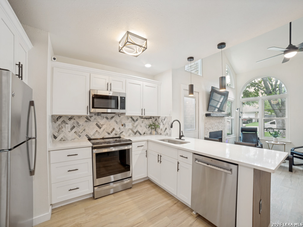 3439 Ridge Ranch San Antonio, TX 78247 - Photo 11 of 25 a kitchen with white cabinets and stainless steel appliances