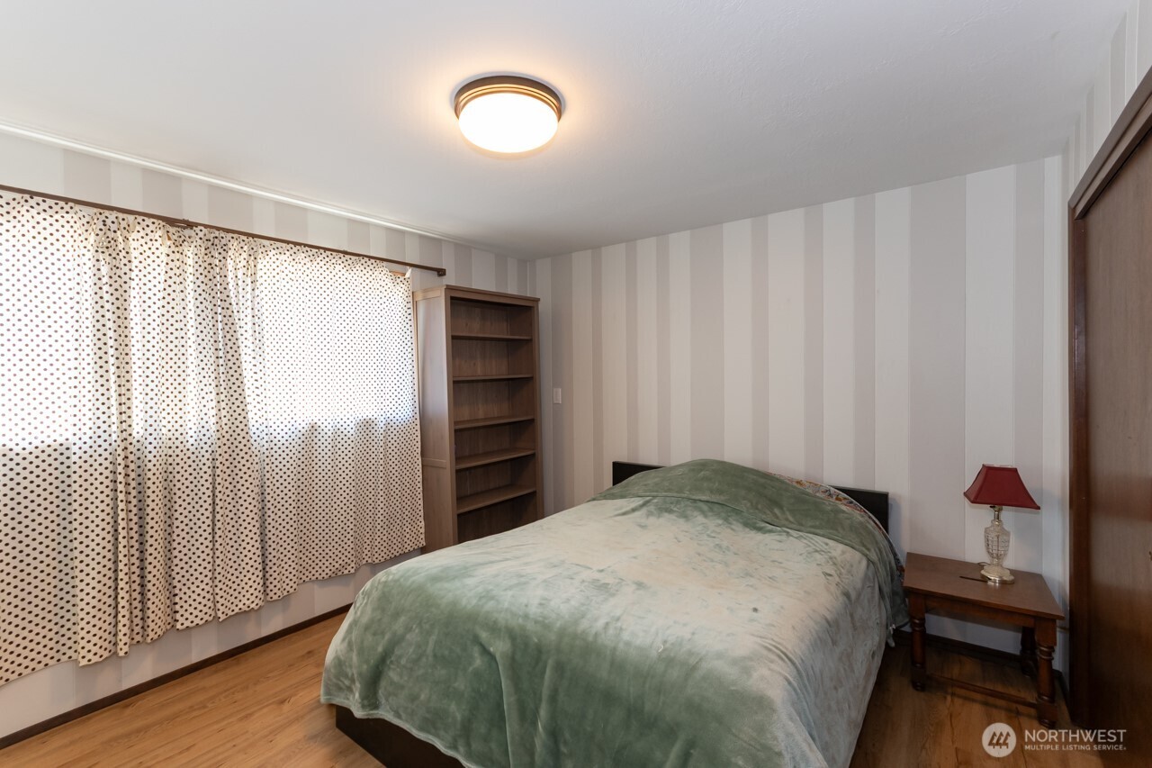 63 East Arnette Road Port Angeles, WA 98362 - Photo 23 of 40 a bedroom with a bed and a window