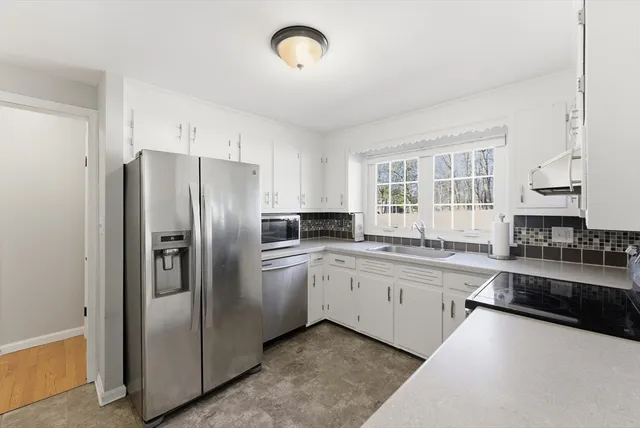 a bathroom with a shower a toilet and a sink