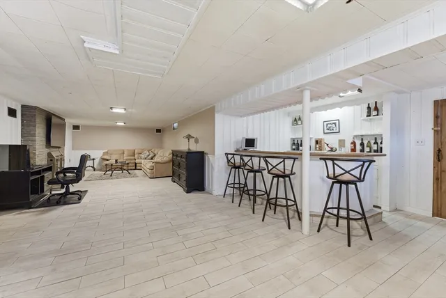 a view of a backyard with potted plants and large tree