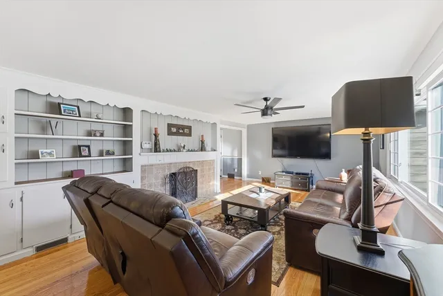 a living room with furniture a rug and a window