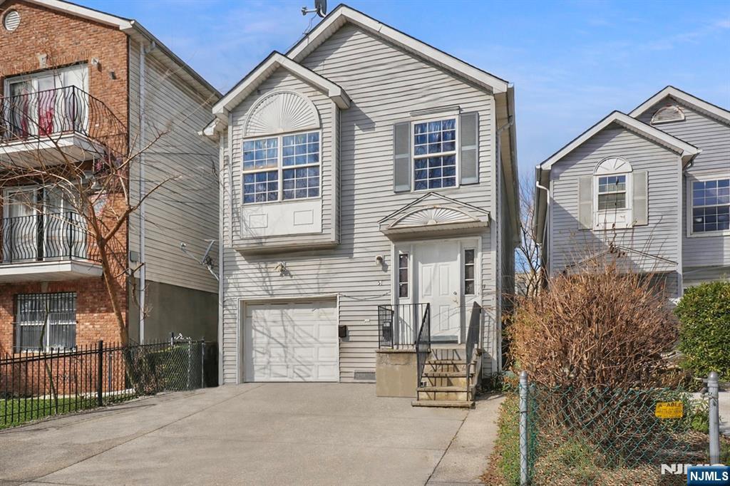51 Demarest Street Newark, NJ 07112 - Photo 1 of 9 a view of a house with a yard and large tree