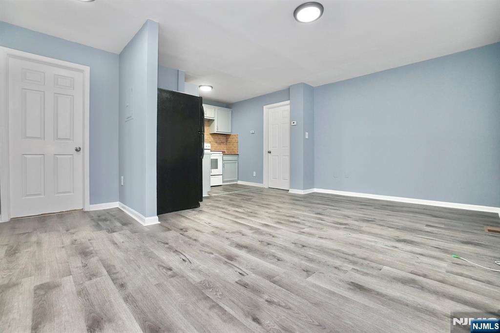 51 Demarest Street Newark, NJ 07112 - Photo 2 of 9 a view of an empty room and wooden floor