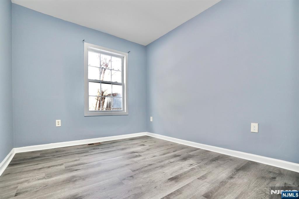 51 Demarest Street Newark, NJ 07112 - Photo 5 of 9 a view of a room with wooden floor and windows