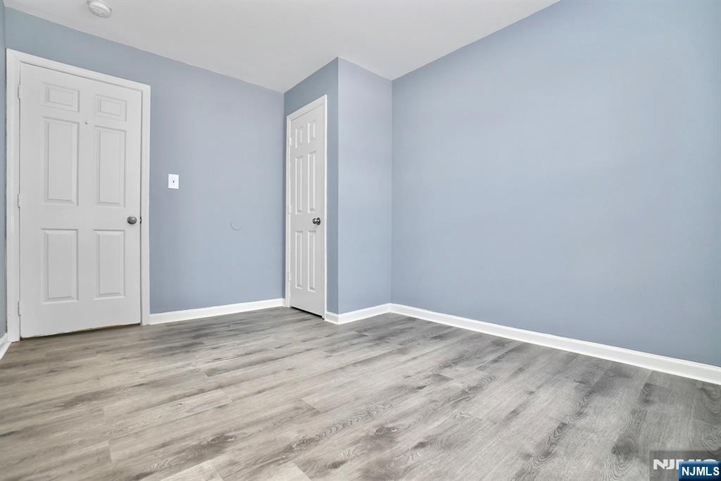 51 Demarest Street Newark, NJ 07112 - Photo 7 of 9 a view of an empty room with wooden floor