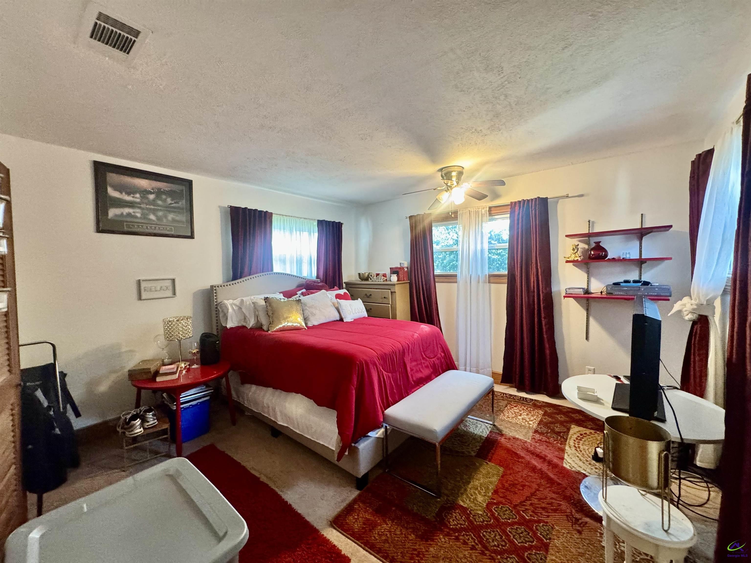 914 Adderton Street Americus, GA 31719 - Photo 23 of 53 a bed room with a bed and a flat screen tv