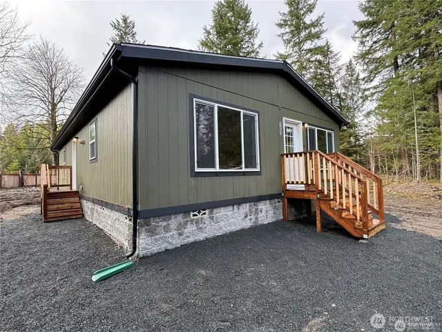 a view of a house with a yard and deck