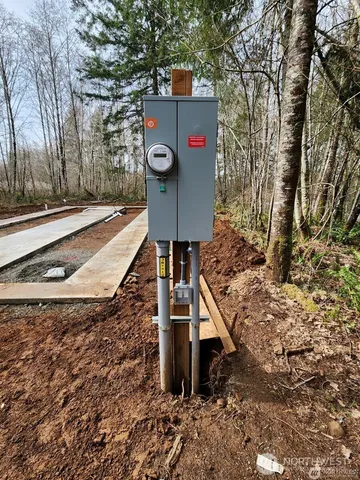a view of water heater room with wooden floor