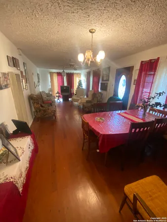 a view of a dining room with furniture and chandelier