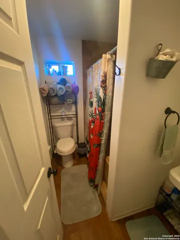 a bathroom with a toilet and a shower