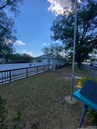 a view of a park with iron fence