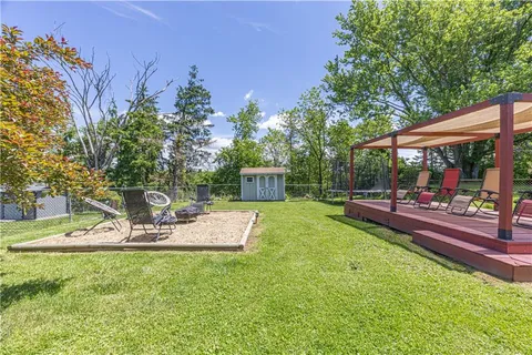 a view of a house with backyard and sitting area