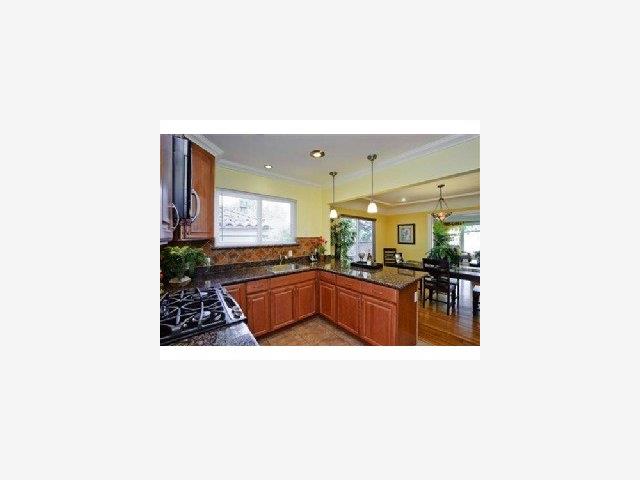 37 Stanley Road Burlingame, CA 94010 - Photo 3 of 9 a kitchen with stainless steel appliances kitchen island a stove a sink and a refrigerator