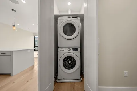 a utility room with sink dryer and washer