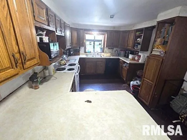 a kitchen with a sink appliances and cabinets