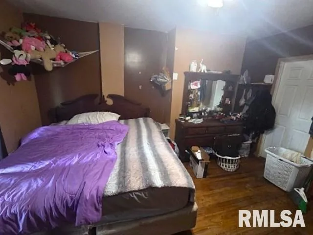 a bedroom with a bed next to a window