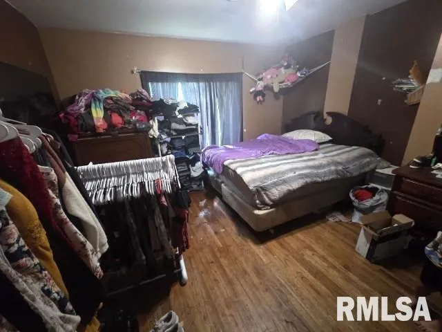 a bedroom with a bed closet and a mirror
