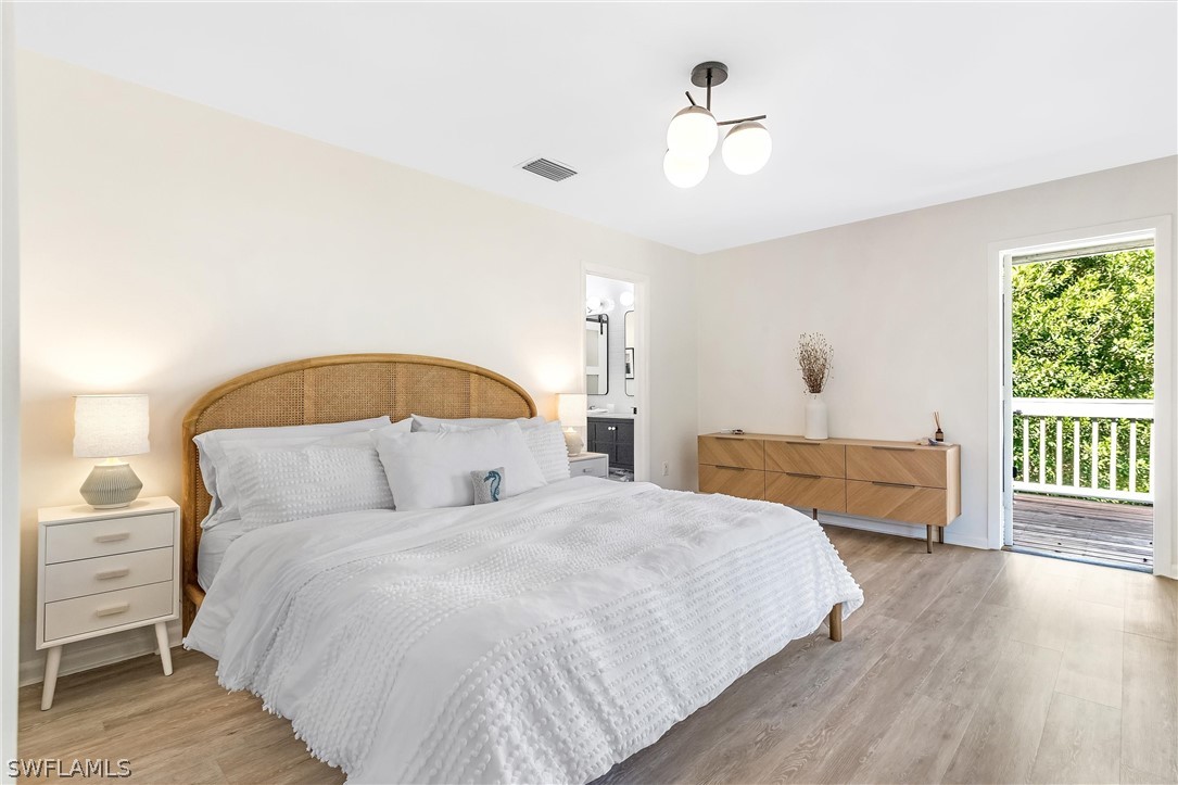 10 Sunset Captiva Lane Captiva, FL 33924 - Photo 18 of 33 a bedroom with a large bed and a chandelier