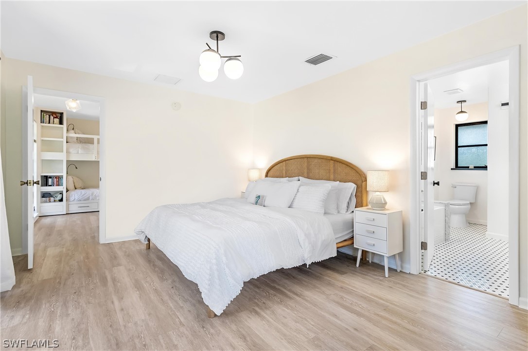 10 Sunset Captiva Lane Captiva, FL 33924 - Photo 19 of 33 a bedroom with a bed and a flat screen tv