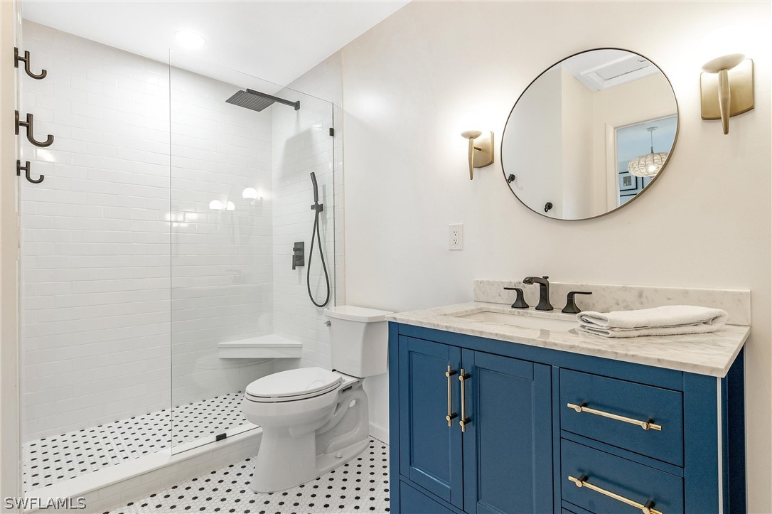 10 Sunset Captiva Lane Captiva, FL 33924 - Photo 25 of 33 a bathroom with a granite countertop sink a toilet and a mirror