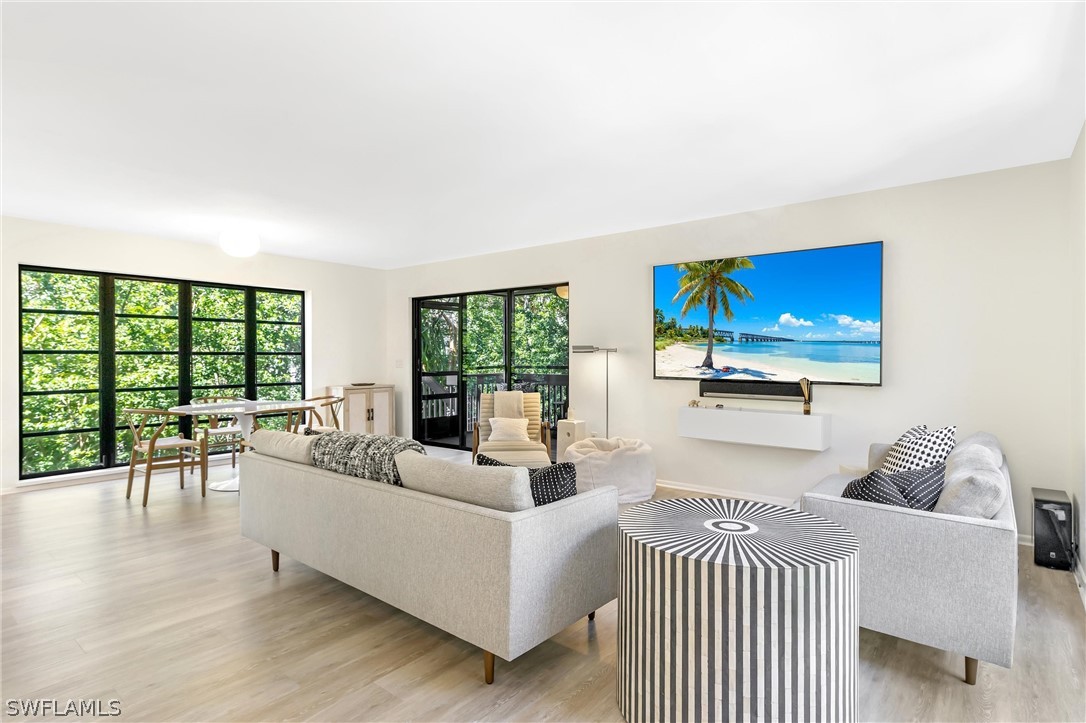 10 Sunset Captiva Lane Captiva, FL 33924 - Photo 6 of 33 a living room with furniture and a flat screen tv
