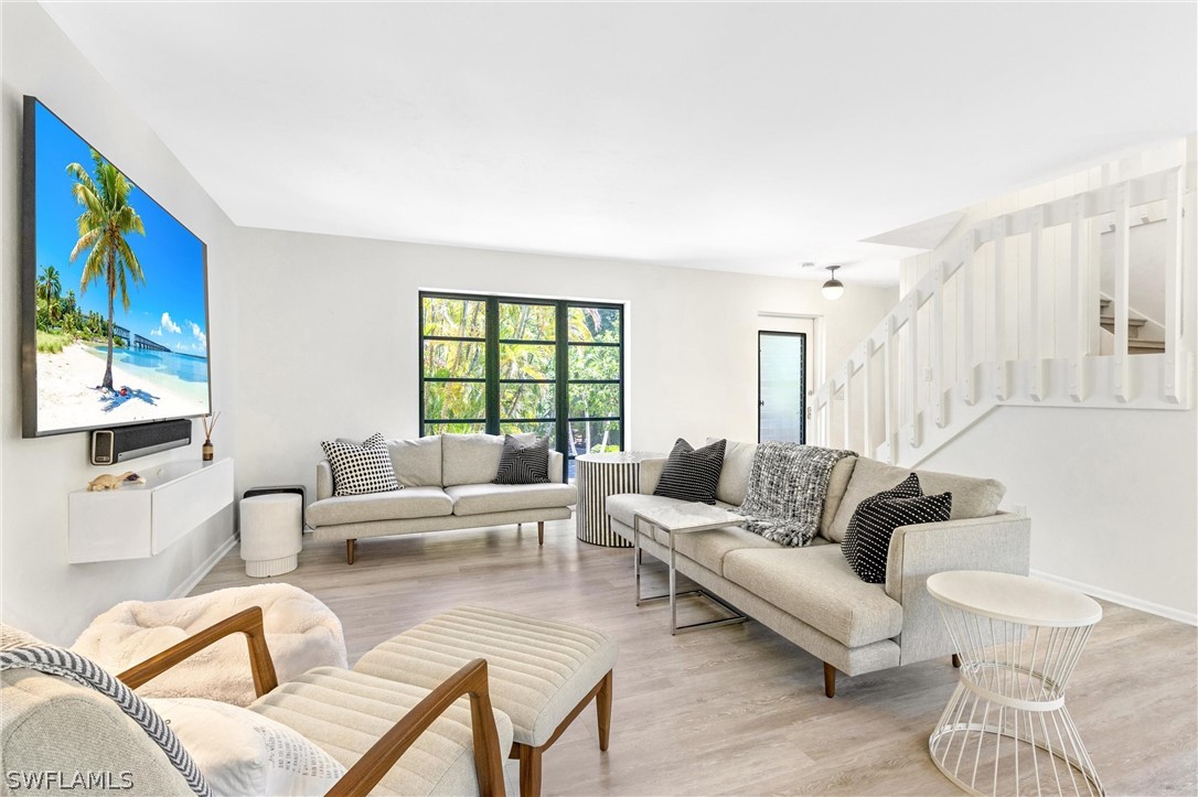 10 Sunset Captiva Lane Captiva, FL 33924 - Photo 7 of 33 a living room with furniture and a flat screen tv