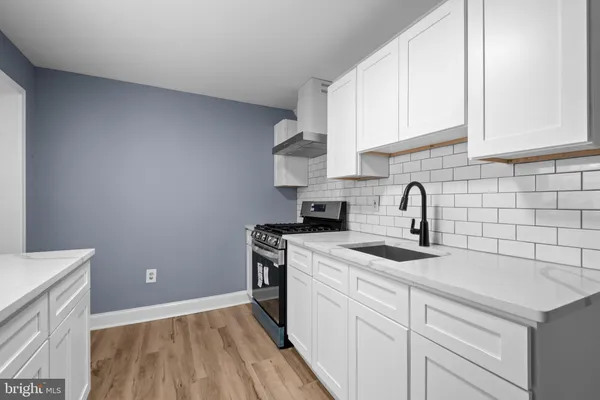 a kitchen with a sink dishwasher and cabinets