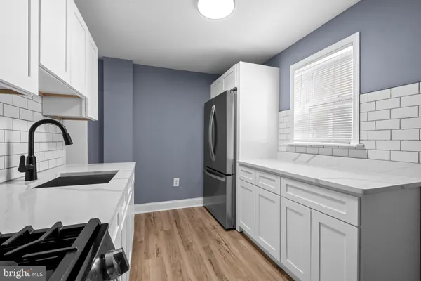 a kitchen with a refrigerator and a sink