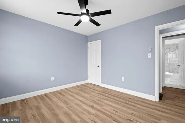 an empty room and wooden floor and windows in a room