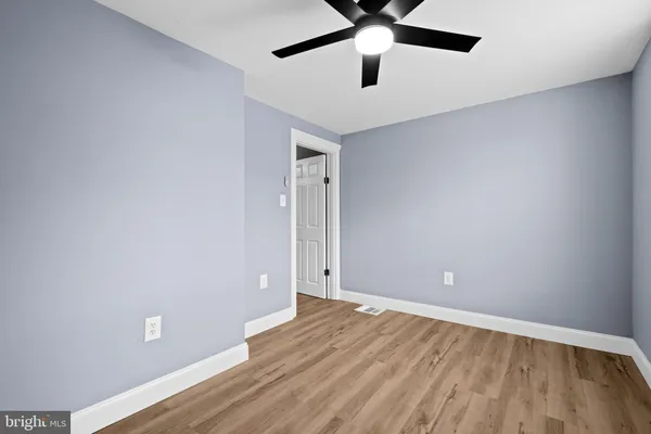 a view of an empty room and wooden floor