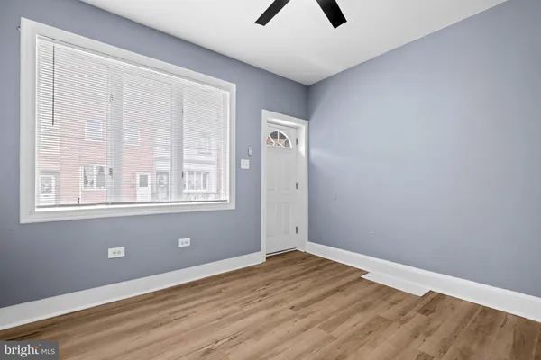 wooden floor in an empty room with a window