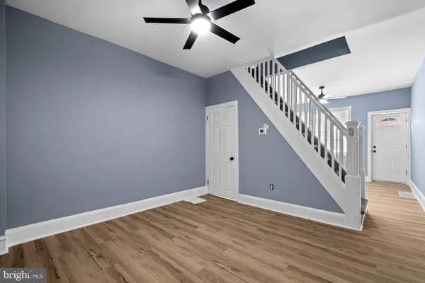 a view of room with stairs and wooden floor