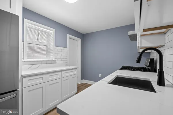 a kitchen with a stove and a window