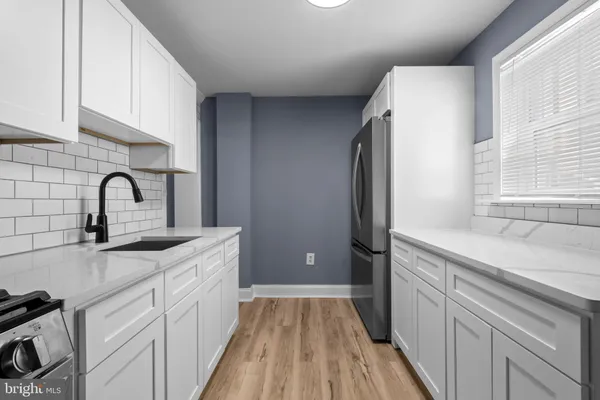 a kitchen with a sink a counter space and appliances
