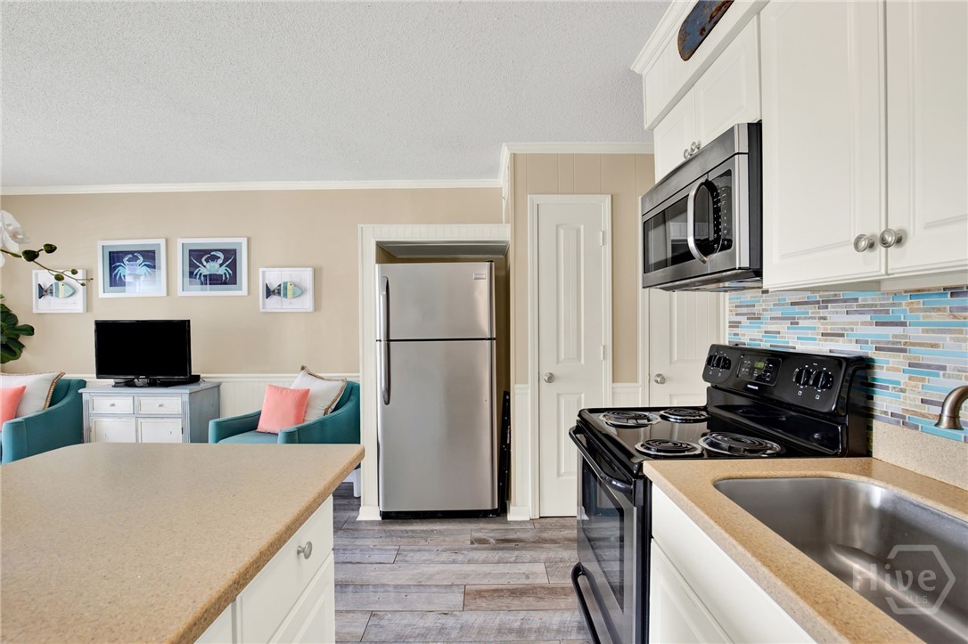 1217 Bay Street, Unit 105B Tybee Island, GA 31328 - Photo 12 of 46 Full Sized Kitchen with Stainless Steel Appliances