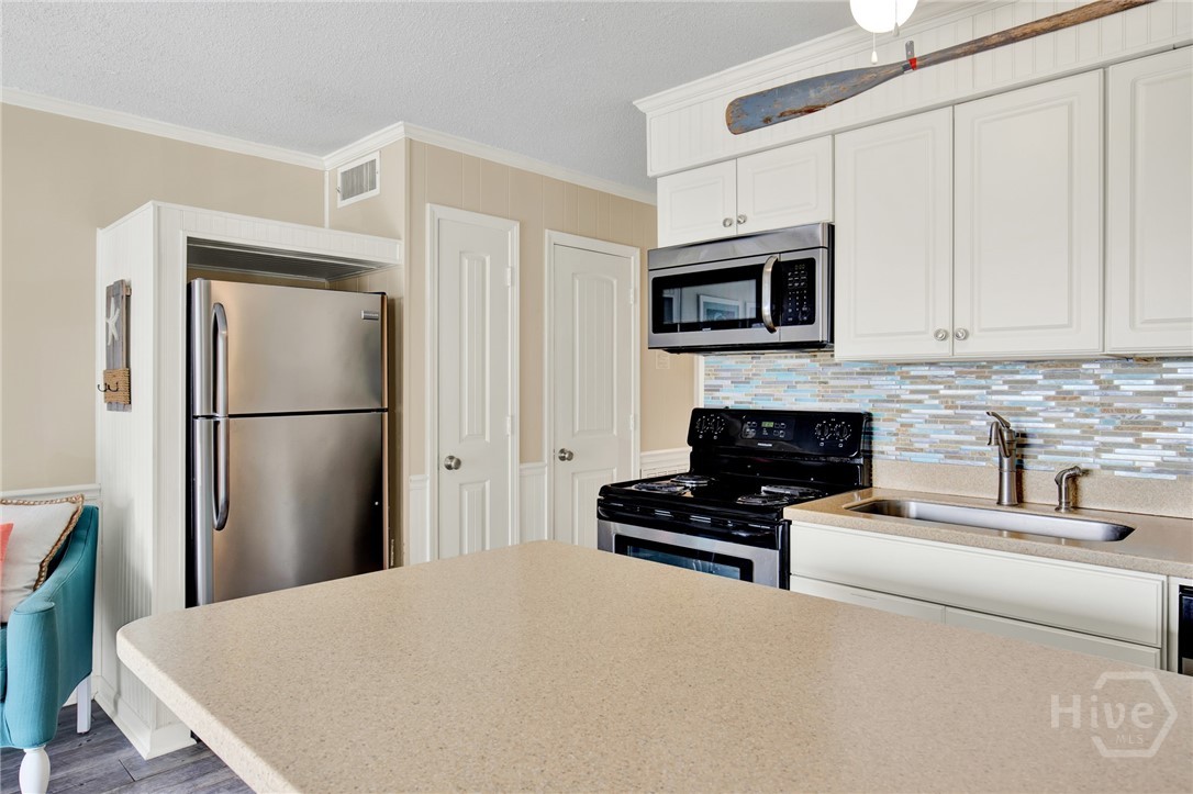 1217 Bay Street, Unit 105B Tybee Island, GA 31328 - Photo 13 of 46 Full Sized Kitchen with Stainless Steel Appliances