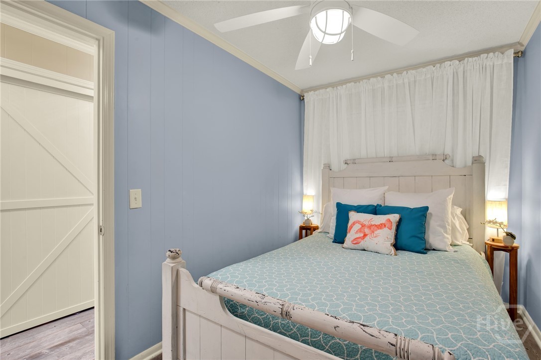 1217 Bay Street, Unit 105B Tybee Island, GA 31328 - Photo 16 of 46 Bedroom with Queen Bed Open to Hallway with Spacio