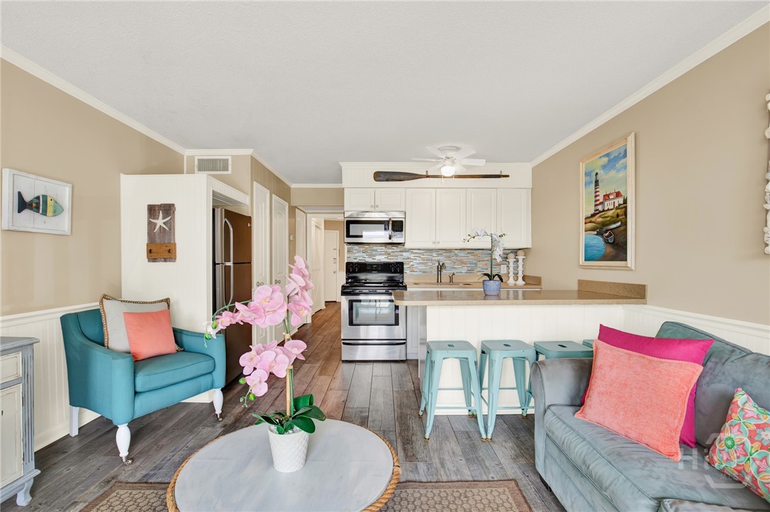 1217 Bay Street, Unit 105B Tybee Island, GA 31328 - Photo 2 of 46 Open Living Area with Sleeper Sofa & Plenty of Nat