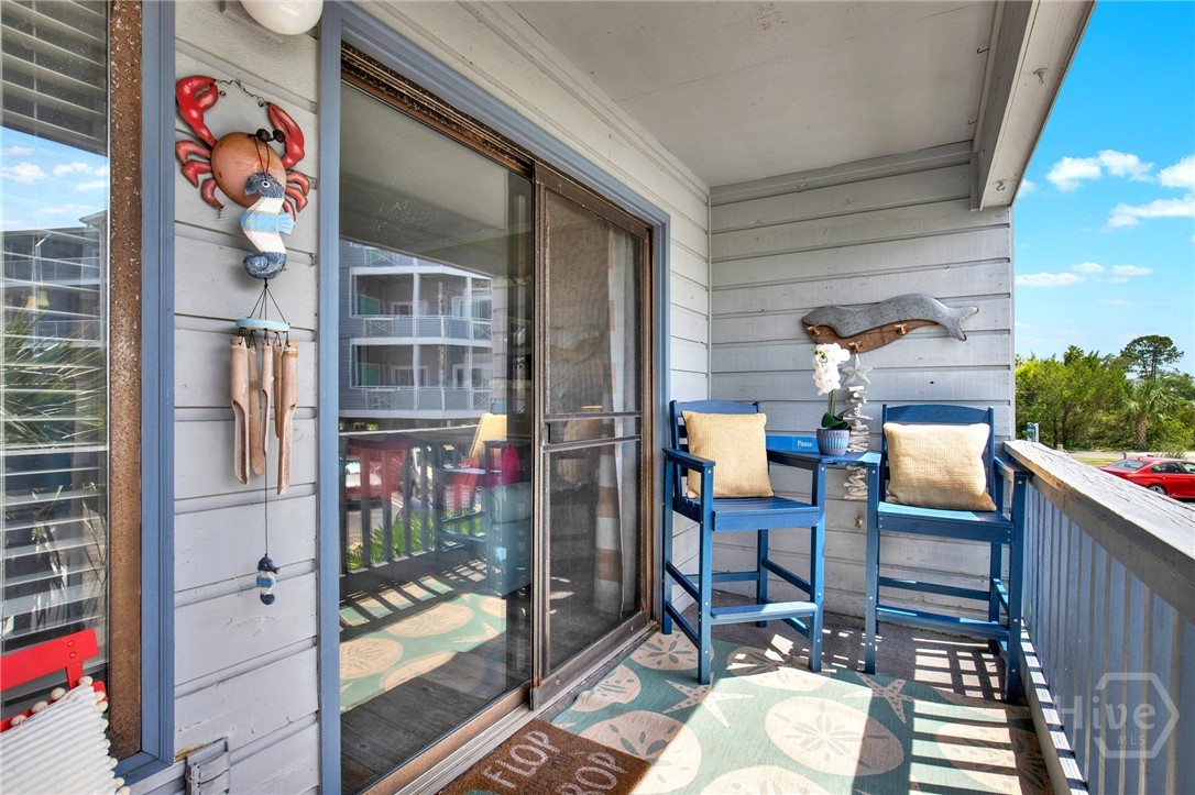 1217 Bay Street, Unit 105B Tybee Island, GA 31328 - Photo 21 of 46 Balcony with Sunset & Partial Water Views!