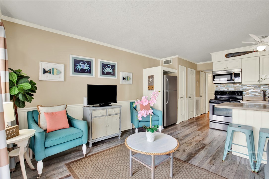 1217 Bay Street, Unit 105B Tybee Island, GA 31328 - Photo 3 of 46 Open Living Area with Sleeper Sofa & Plenty of Nat