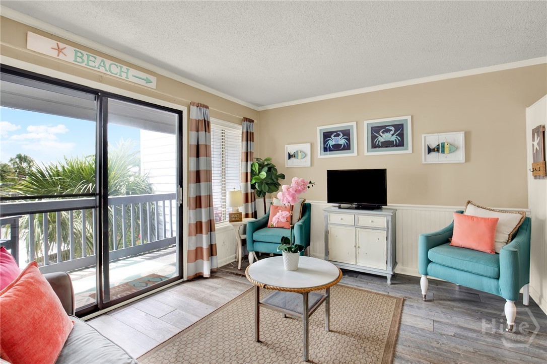 1217 Bay Street, Unit 105B Tybee Island, GA 31328 - Photo 5 of 46 Open Living Area with Sleeper Sofa & Plenty of Nat