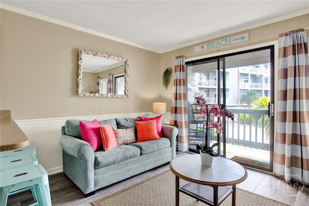 1217 Bay Street, Unit 105B Tybee Island, GA 31328 - Photo 6 of 46 Open Living Area with Sleeper Sofa & Plenty of Nat