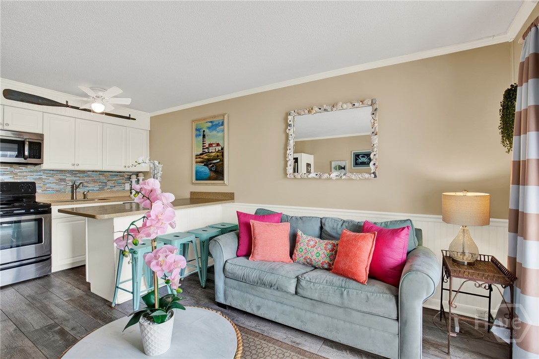 1217 Bay Street, Unit 105B Tybee Island, GA 31328 - Photo 7 of 46 Open Living Area with Sleeper Sofa & Plenty of Nat